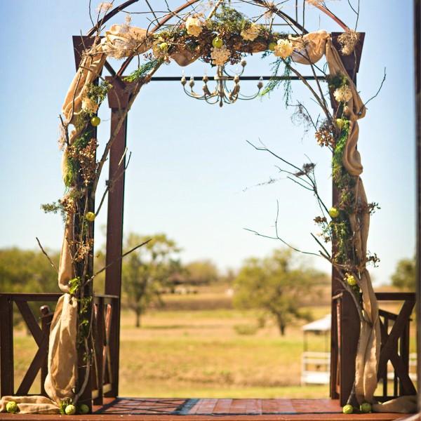 outdoor arch with flowers and chandelier