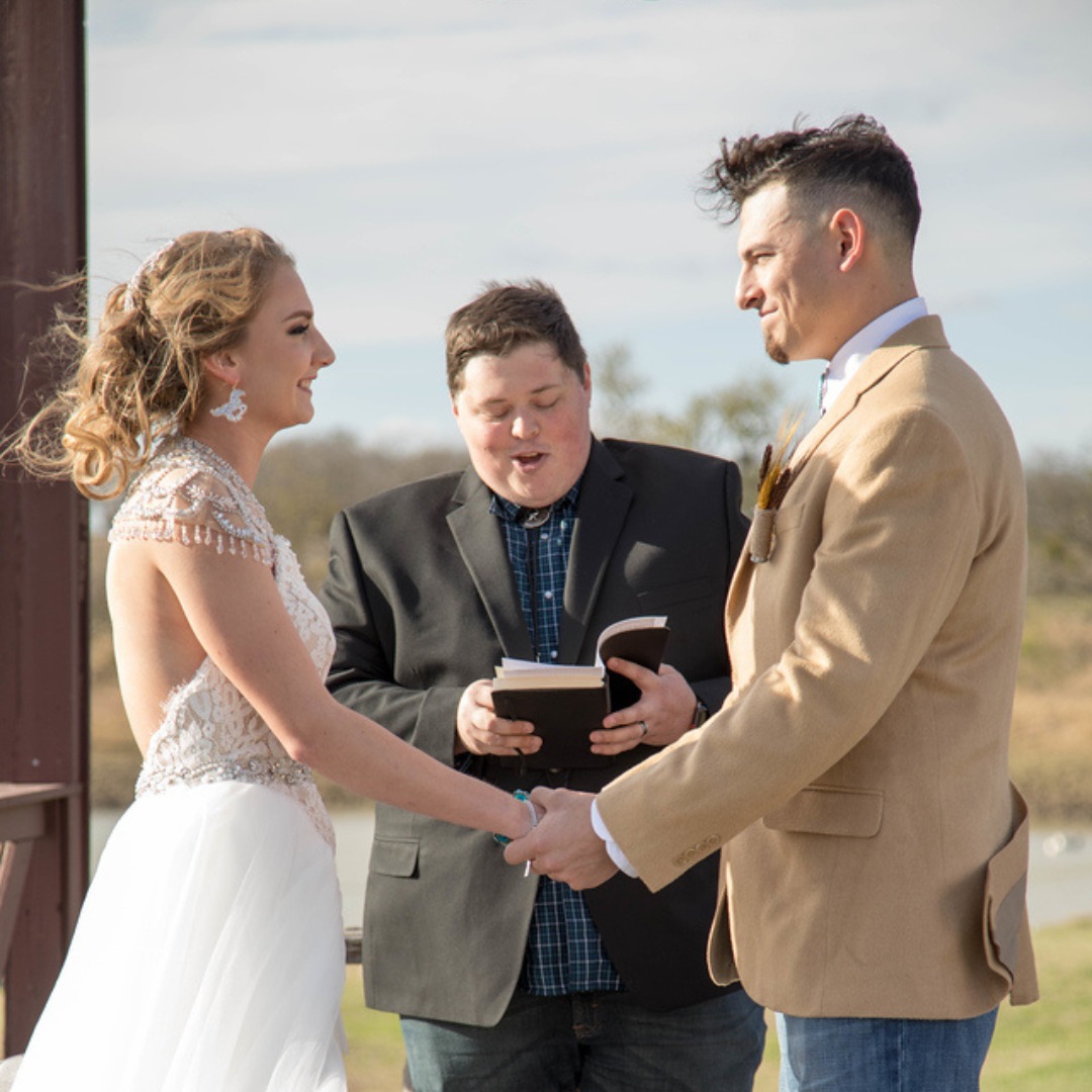 bride and groom saying vows during outdoor wedding ceremony