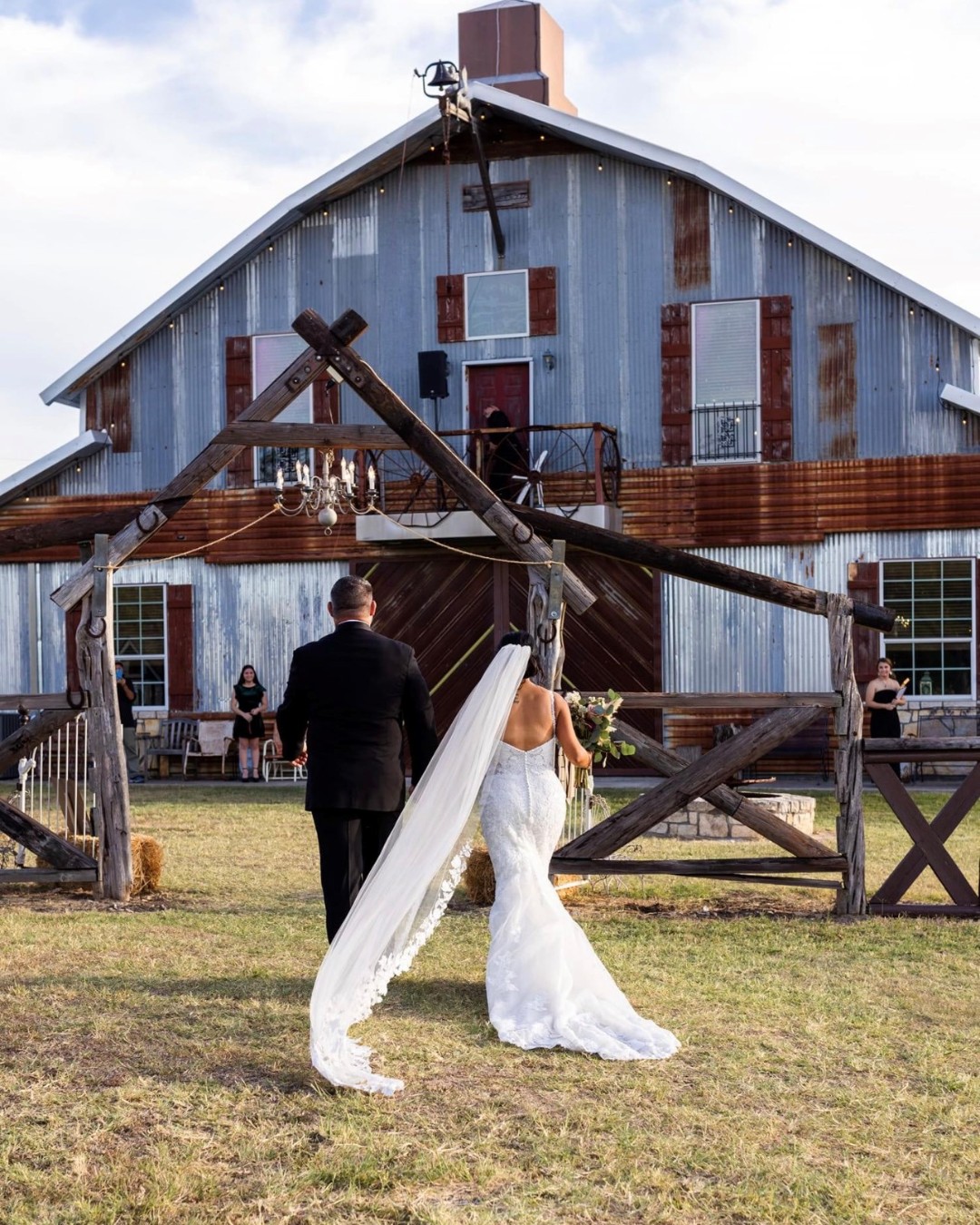 bride and groom walking toward Jones Barn venue